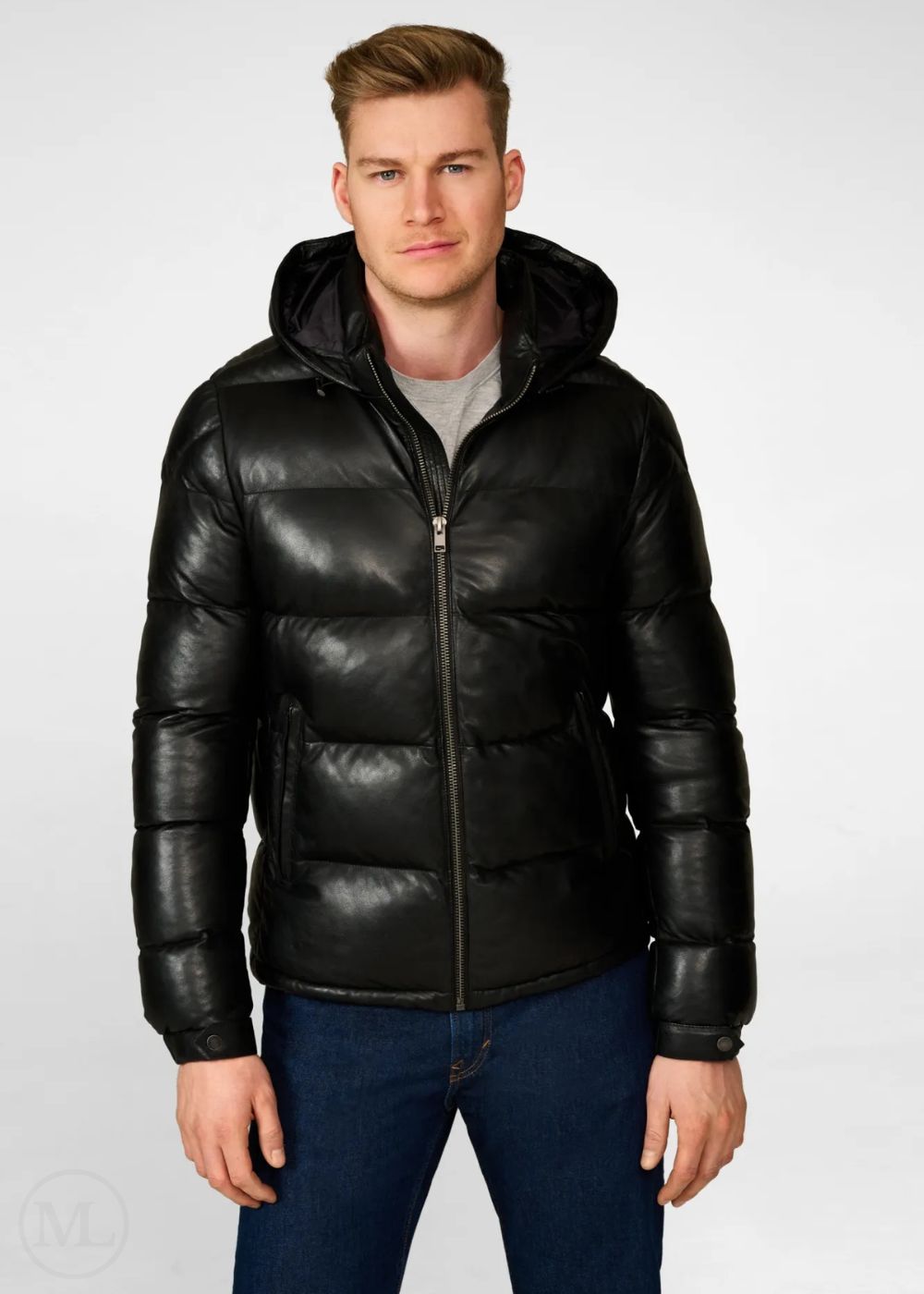 Man wearing a black leather puffer jacket on a white background