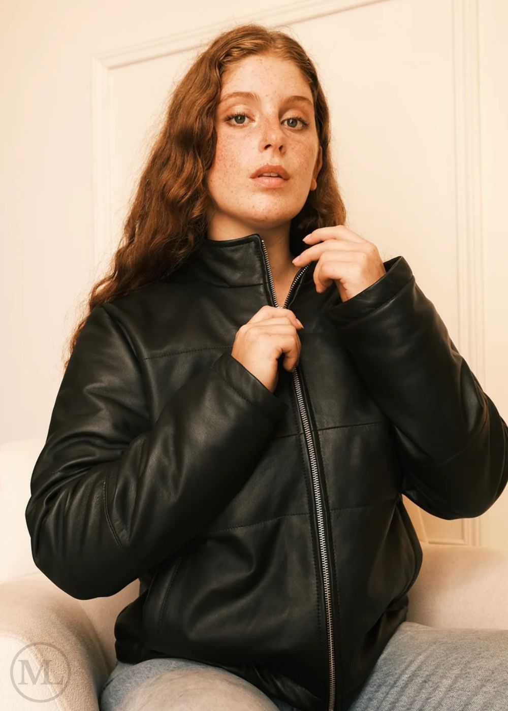Women wearing a black leather Puffer down jacket , hands on zipper shot